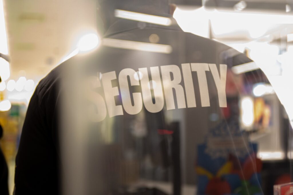 Security guard standing inside commercial building nearby the wi